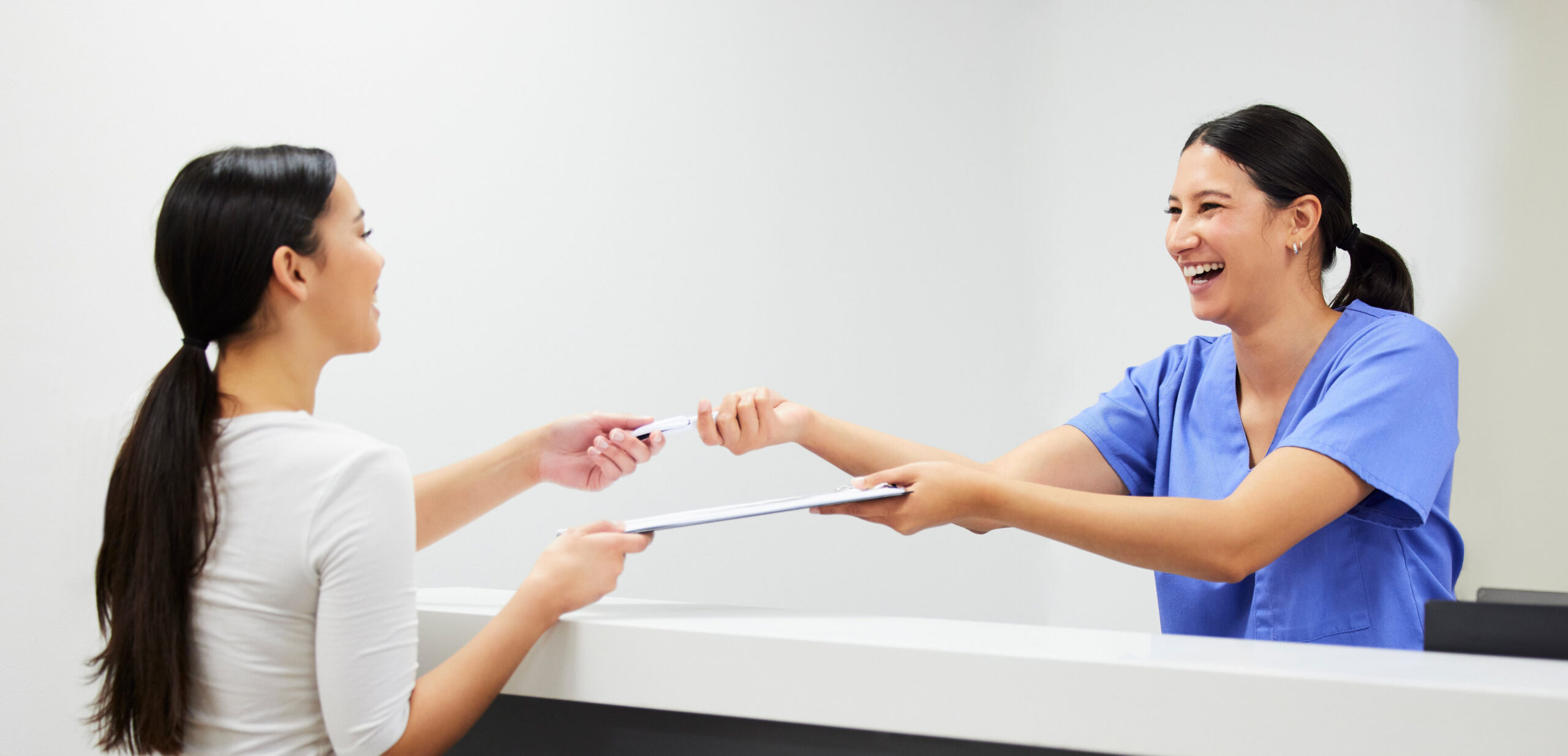 Documents, reception and a nurse helping a patient in the hospital during an appointment or checkup. Application form, happy and a woman medical assistant at a health clinic for check in or sign up
